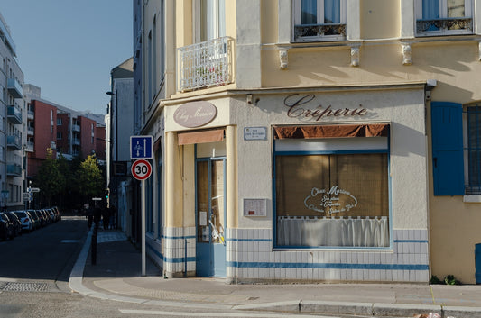A street corner with cars parked on the side of it