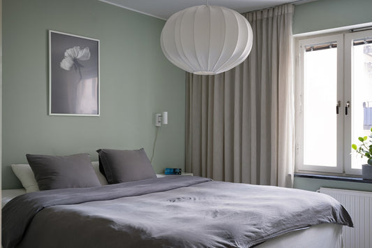 A bedroom with a large bed and a large window